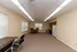 Spacious open-concept apartment room with warm lighting, featuring a cozy dining area and a well-equipped kitchen.