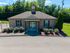 Charming single-story brick building with beautiful landscaping and a welcoming entrance.