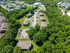 Scenic aerial view of a peaceful residential neighborhood surrounded by lush greenery, offering tranquil living with convenient parking and well-maintained pathways.