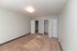 Spacious bedroom with plush carpet and dual closets, perfect for comfortable living.