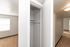 Bright and welcoming hallway featuring a spacious closet and natural light streaming through nearby windows.
