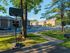 Charming apartment complex with brick buildings, lush greenery, and a community basketball court for active living.
