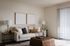 Charming living room with cozy beige sofa, modern decor, and abundant natural light through vertical blinds.