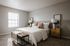 Bright and inviting bedroom featuring a cozy king-sized bed with stylish pillows, a modern bedside table, and soft natural lighting through a large window.