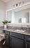 Elegant bathroom with sleek granite countertop, modern fixtures, and decorative plant for a touch of nature.