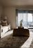 Inviting living room with a cozy sofa, modern decor, and natural light streaming through large windows highlighting a beautiful view.