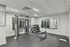 Modern fitness center with state-of-the-art equipment, mirrored wall, and a sleek, inviting design.