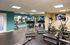 Modern fitness center with high-quality equipment, including treadmills, ellipticals, and weights in a bright, inviting space.