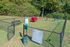 Inviting fenced dog park showcasing playful agility equipment and lush greenery for a perfect pet-friendly community.