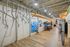 Modern indoor kayak storage area with sleek metal racks and colorful kayaks on display, perfect for adventure enthusiasts.