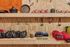 Camping gear display with neatly organized cooking pots, fuel canisters, sleeping bags, and headlamps on wooden shelves, creating an adventurous and ready-to-explore vibe.