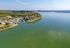 Stunning aerial view of a scenic lakeside community surrounded by lush greenery and serene waters.