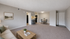 Inviting open-plan living room with cozy seating, stylish coffee table, and a modern dining area, seamlessly connected to a chic kitchen.