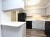 Modern kitchen with sleek gray cabinets, elegant countertops, and state-of-the-art appliances, perfect for culinary creativity.
