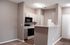 Modern kitchen with sleek cabinetry, integrated appliances, and an inviting breakfast bar in a cozy apartment setting.