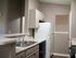 Modern kitchen with sleek countertops, ample cabinetry, and essential appliances for a functional cooking space.