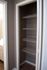 Spacious apartment closet with multiple wire shelves, perfect for organizing and maximizing storage.