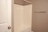 Modern bathroom featuring a sleek bathtub, neutral toned walls, and a stylish towel bar.