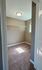 Inviting walk-in closet with beige carpet, ample shelving, and a gentle, natural light glow.