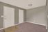 Inviting entryway with neutral tones, sleek lighting, and plush carpeting, offering a warm welcome.