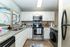 Contemporary kitchen featuring sleek stainless steel appliances, elegant granite countertops, and stylish white cabinetry.