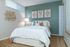 Cozy and modern bedroom featuring stylish wall art, plush bedding, and soft ambient lighting for a relaxing atmosphere.