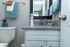 Chic bathroom with sleek granite countertop, modern fixtures, and a fresh blue towel set for a serene ambiance.