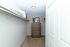 Inviting walk-in closet with plush carpeting, elegant wooden dresser, and modern shelving for organized living.