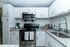 Modern kitchen with sleek white cabinets, stainless steel appliances, and elegant granite countertops.