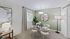 Chic dining area with a round glass table, plush seating, and stylish decor under modern lighting.