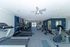 Contemporary fitness center with state-of-the-art treadmills, stationary bikes, and ample natural light.