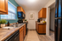 Charming kitchen with modern appliances, wooden cabinetry, and elegant countertops, enhanced by natural light and stylish decor.