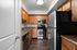 Modern kitchen with sleek stainless steel appliances, warm wood cabinetry, and elegant countertops.