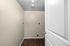 Bright utility room with sleek hardwood flooring and modern fixtures.