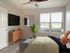 furnished bedroom with wood style floors
