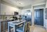 Modern kitchen with sleek stainless steel appliances, chic cabinetry, and a cozy breakfast nook.