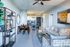 Modern open-concept living space featuring a cozy seating area, stylish dining set, and sleek kitchen with stainless steel appliances.