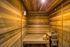 Inviting wooden sauna interior with warm lighting and relaxation bench.
