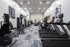 Modern fitness center with state-of-the-art treadmills, weight machines, and contemporary decor, offering a vibrant and energizing workout environment.