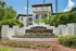 Emerald Palms Apartment Homes exterior featuring lush landscaping and elegant architecture under a clear blue sky.