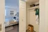 Inviting bedroom with modern decor, cozy bed, and spacious closet, perfect for restful living.