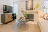Chic living room featuring modern decor, sleek wooden floors, a cozy fireplace, and a stylish TV setup.