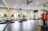 Modern fitness center with state-of-the-art treadmills, exercise bikes, and a punching bag, offering a spacious and well-lit environment.