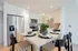 Modern kitchen boasting sleek stainless steel appliances, a chic island with stylish seating, and contemporary cabinetry for an elegant culinary experience.