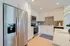 Modern kitchen with sleek stainless steel appliances, elegant white cabinetry, and sophisticated gray backsplash.