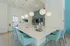 Elegant modern kitchen with a large marble island, stylish pendant lighting, and plush blue bar stools, perfect for entertaining.