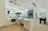 Modern open-concept kitchen with sleek countertops, stylish pendant lighting, and spacious seating area overlooking a vibrant garden view.