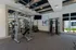 Modern fitness center with state-of-the-art equipment, stylish decor, and large windows providing a bright and inviting atmosphere.