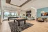 Luxurious clubhouse interior featuring a modern pool table, chic seating areas, and a stylish breakfast bar with trendy lighting.