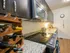 Modern kitchen with granite countertops, sleek cabinets, wine rack, and stainless steel appliances for a stylish cooking experience.